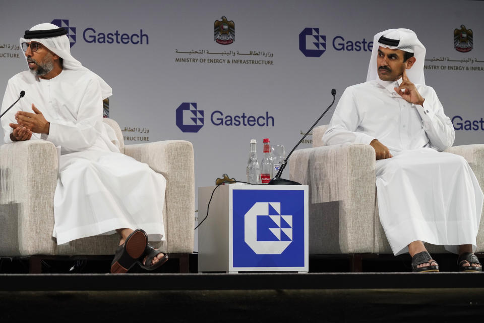 Qatar's Minister of State for Energy Affairs Saad Sherida al-Kaabi, right, listens to Emirati Energy and Infrastructure Minister Suhail al-Mazrouei, left, during the Gastech 2021 conference in Dubai, United Arab Emirates, Tuesday, Sept. 21, 2021. Energy officials from Qatar and Turkey, long-standing foes of the United Arab Emirates, descended on Dubai along with hundreds of other executives on Tuesday, flocking to the largest gas expo in the world and the industry's first in-person conference since the pandemic began. (AP Photo/Jon Gambrell)