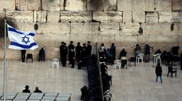 Ultra-Orthodox Jewish men (L) and women (R) pray in different sections of the Western Wall in Jerusalem's Old City on February 2, 2016