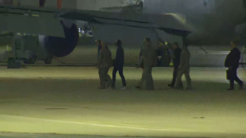 A screengrab from a video shows an individual who appears to be Travis King, third from right, deplaning after landing at Kelly Field near San Antonio on September 28, 2023. - CNN