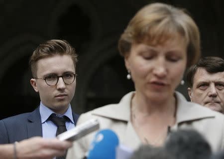 Anatoly Litvinenko (L), the son of murdered KGB agent Alexander Litvinenko, listens as his mother Mariana speaks to members of the media as she leaves the High Court in central London, Britain July 31, 2015. REUTERS/Peter Nicholls/Files