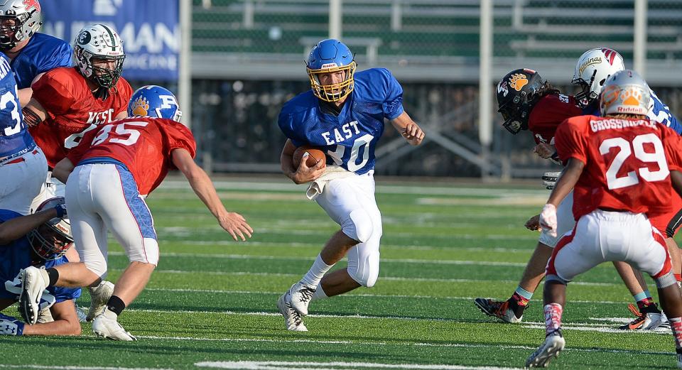 East's quarterback Cody Vacco of East Canton finds running room during the 30th annual Repository East-West All-Star Football Game at GlenOak, July 20, 2019.