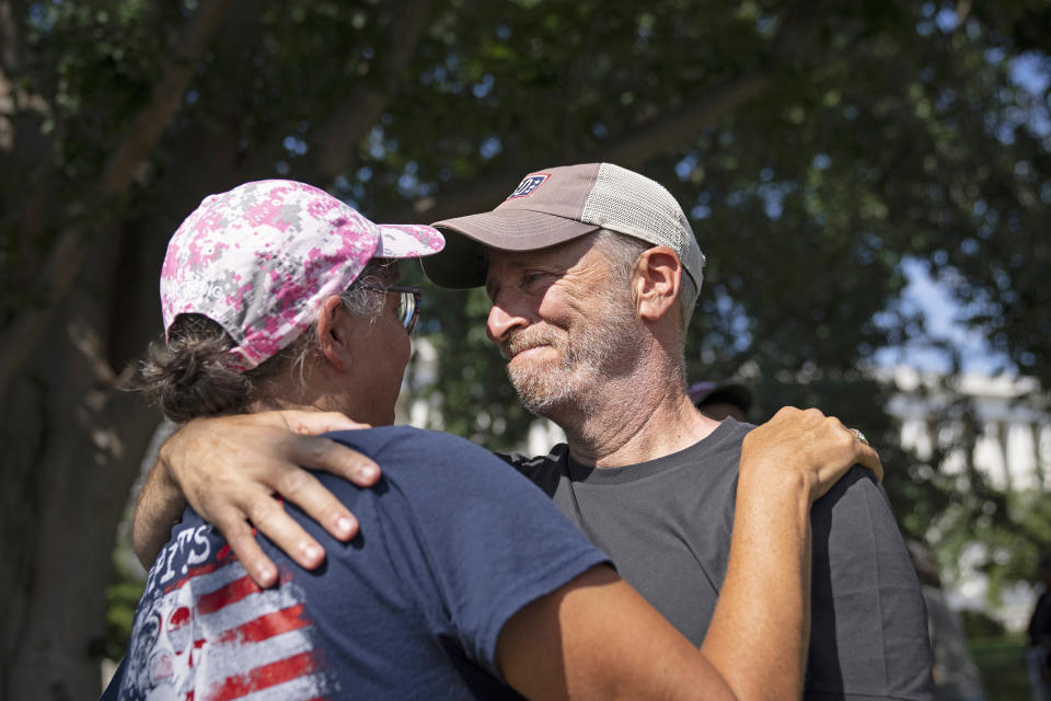 Image: Comedian and activist Jon Stewart embraces Susan Zeier, mother-in-law of the late Sgt. First Class Heath Robinson, before the Senate vote on the PACT Act outside the Capitol on Aug. 2, 2022. (Drew Angerer / Getty Images)