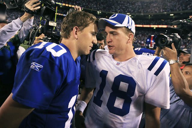 <p>Travis Lindquist/Getty</p> Eli Manning and Peyton Manning in 2006