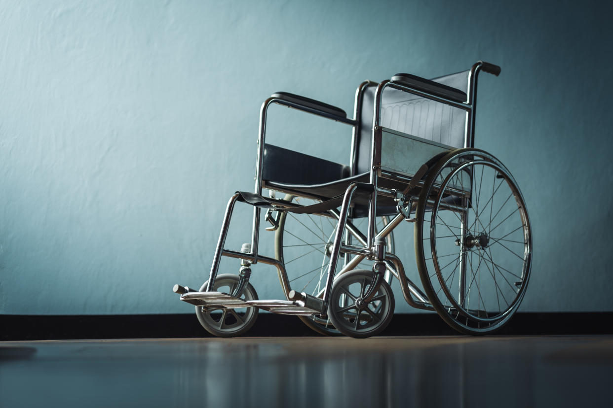 Empty wheelchair against background