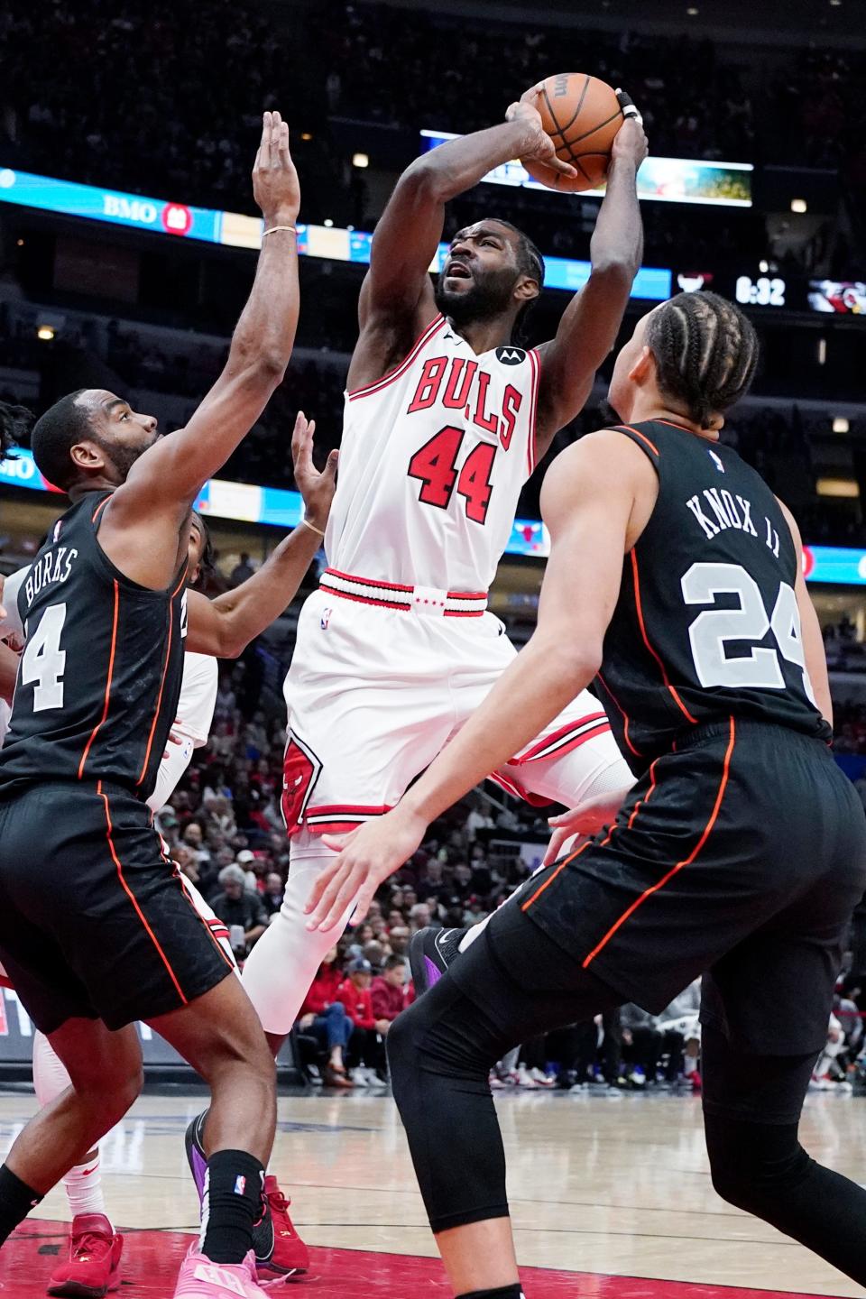 Chicago Bulls forward Patrick Williams, center, shoots against Detroit Pistons guard Alec Burks, left, and forward Kevin Knox II during the first half at United Center in Chicago on Sunday, Nov. 12, 2023.