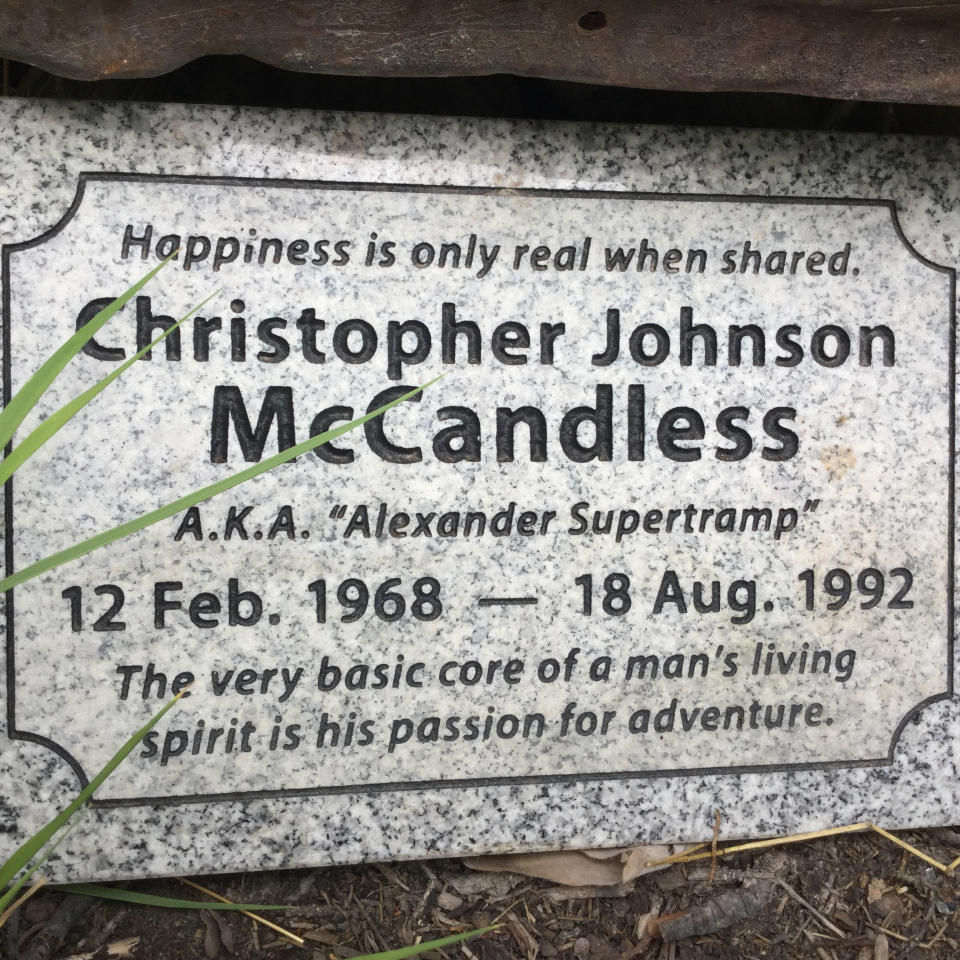 This July 2018, photo provided by Pamela Szatanek shows shows a granite memorial in backcountry Alaska placed near the abandoned bus where Christopher McCandless starved to death in 1992 off the Stampede Trail near Healy, Alaska. Local officials are tired of the deaths and multiple rescues linked to the decrepit old bus whose legendary status continues to lure adventurers to one of Alaska's most unforgiving hinterlands, and now they want it removed, something the state has no intention of doing. (Pamela Szatanek via AP)