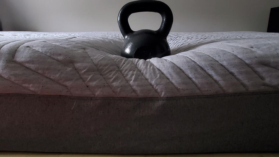 Casper Wave Hybrid Snow review: 56lb weight placed on the edge of the mattress