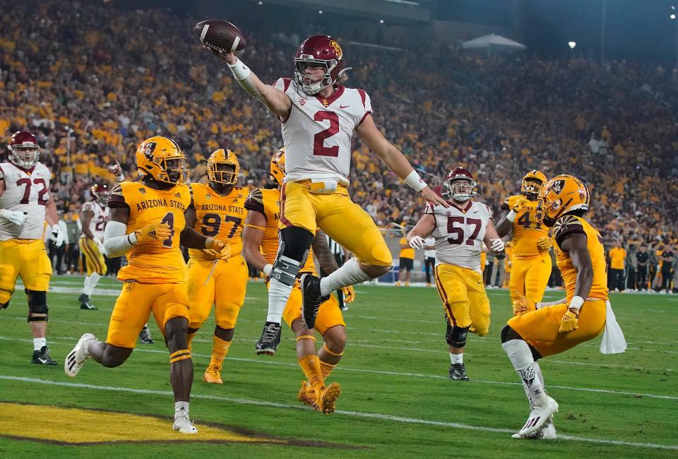 Southern California quarterback Jaxson Dart (2) celebrates a touchdown against Arizona State during the first half of an NCAA college football game Saturday, Nov. 6, 2021, in Tempe, Ariz. (AP Photo/Darryl Webb)