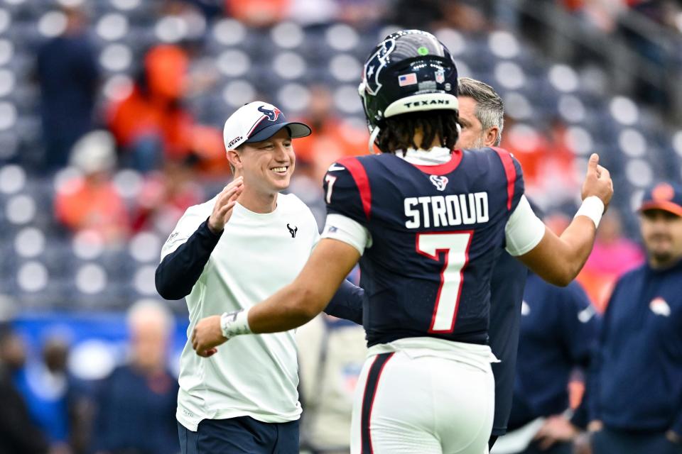 Houston Texans offensive coordinator Bobby Slowik greet quarterback C.J. Stroud (7) prior to an NFL football game against the Denver Broncos, Sunday, Dec 3, 2023, in Houston.