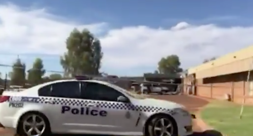 A 17-year-old boy has been charged with murder after a woman's body was found in a wheelie bin in Newman, in Western Australia's Pilbara region. Pictured is the scene.