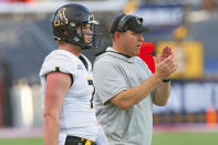 Appalachian State head coach Shawn Clark, right, claps next to quarterback Chase Brice (7) after an extra point during the first half of the Sun Belt Conference championship NCAA college football game against Louisiana-Lafayette in Lafayette, La., Saturday, Dec. 4, 2021. (AP Photo/Matthew Hinton)