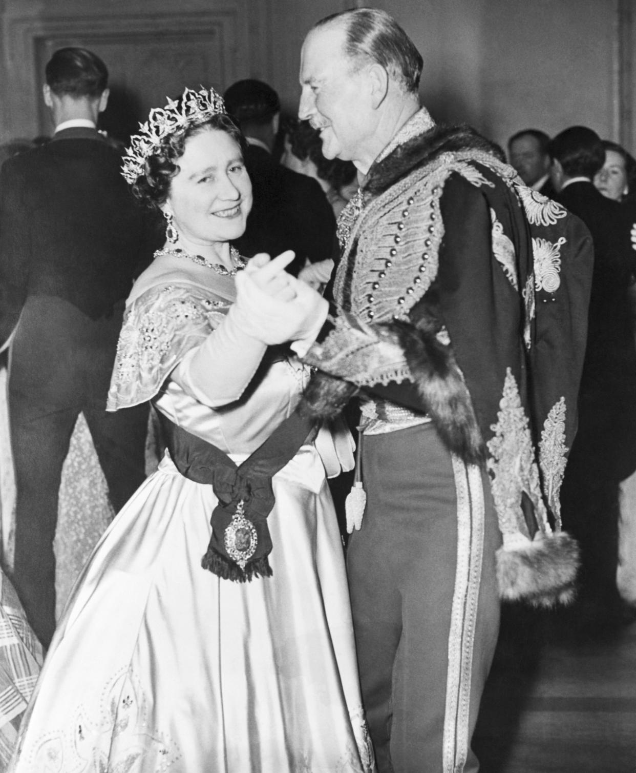 (Original Caption) 11/29/1954- London, England- Queen Mother Elizabeth is shown dancing with Hussar Colone Combe at the Balaclava Ball in London. Her daughter, Queen Elizabeth II, was also at the affair which was in observance of the Centenary of the Battle of Balaclava.