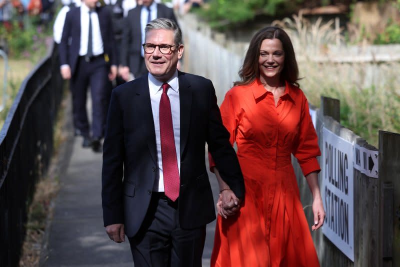 British Labor Party leader Keir Starmer (L) arrives with his wife Victoria Starmer at a polling station in London to vote during Thursday's snap election. An authoritative exit poll released moments after the voting concluded showed Starmer will be the country's next next prime minister as Labor appeared en route to a landslide victory. Photo by Neil Hall/EPA-EFE