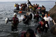 Migrants arrive on the shores of the Greek island of Lesbos after crossing the Aegean Sea from Turkey on a dinghy on September 9, 2015