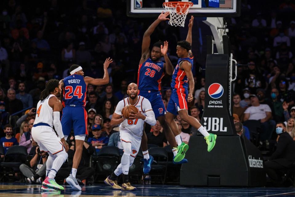 New York Knicks forward Taj Gibson passes the ball as Detroit Pistons center Isaiah Stewart and forward Jamorko Pickett  defend during the first half at Madison Square Garden.