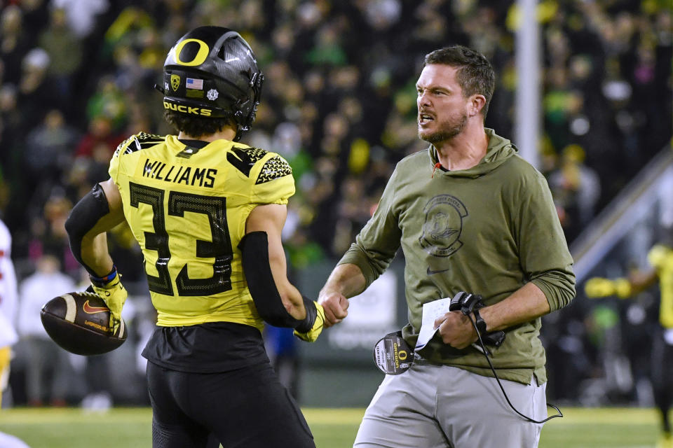 Oregon coach Dan Lanning greets defensive back Evan Williams (33) after Williams recovered a Southern California fumble during the second half of an NCAA college football game Saturday, Nov. 11, 2023, in Eugene, Ore. (AP Photo/Andy Nelson)