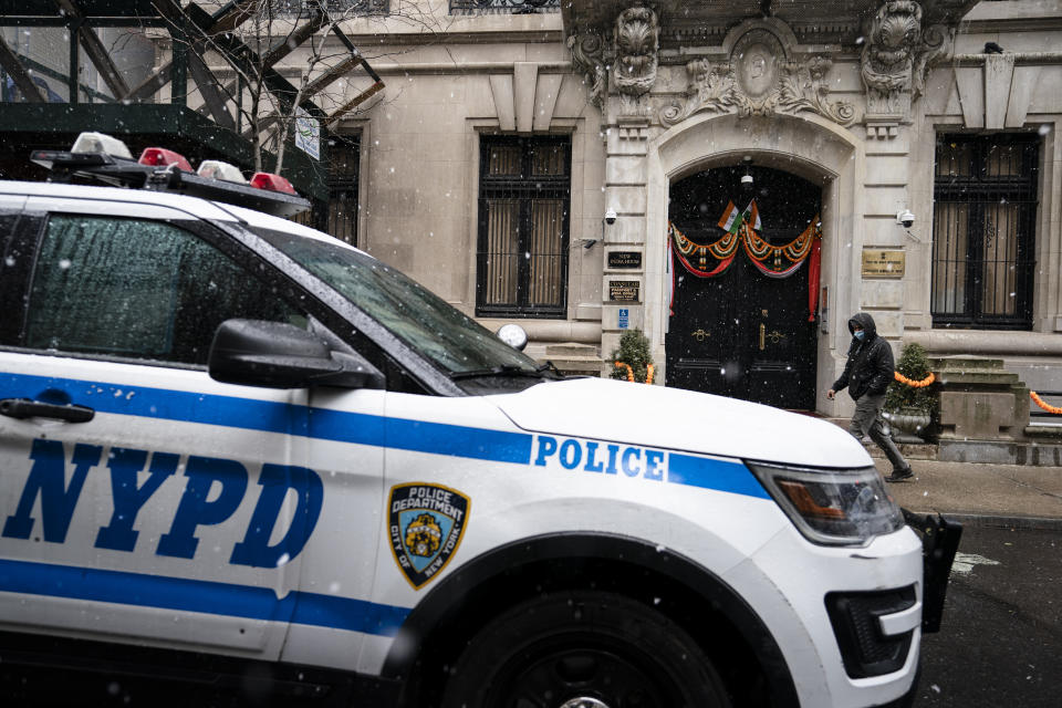 New York Police Department vehicles park outside the Consulate General of India during a protest, Tuesday, Jan. 26, 2021, in the Manhattan borough of New York. Tens of thousands of protesting farmers have marched, rode horses and drove long lines of tractors into India's capital, breaking through police barricades to storm the historic Red Fort. The farmers have been demanding the withdrawal of new laws that they say will favor large corporate farms and devastate the earnings of smaller scale farmers. Republic Day marks the anniversary of the adoption of India’s constitution on Jan. 26, 1950. (AP Photo/John Minchillo)