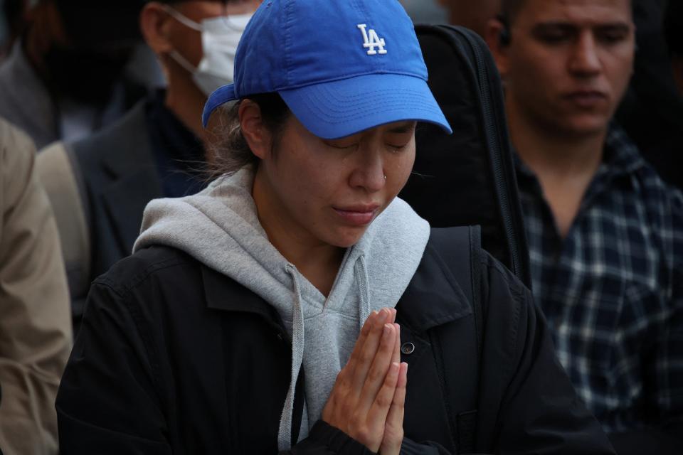 A woman pays respects near the scene of a crowd crush (REUTERS)