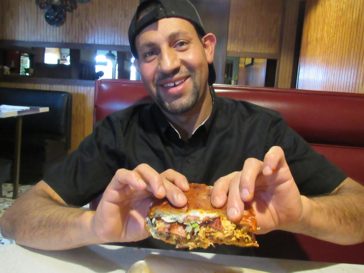 Victor Villasenor holds up half of a torta pambazo at Tasty Tacos, a new restaurant at 1776 E. Dublin-Granville Road in Northland. Villasenor and his sister, Monica, opened the storefront in the former Bruno’s Pizza & Restaurant site.