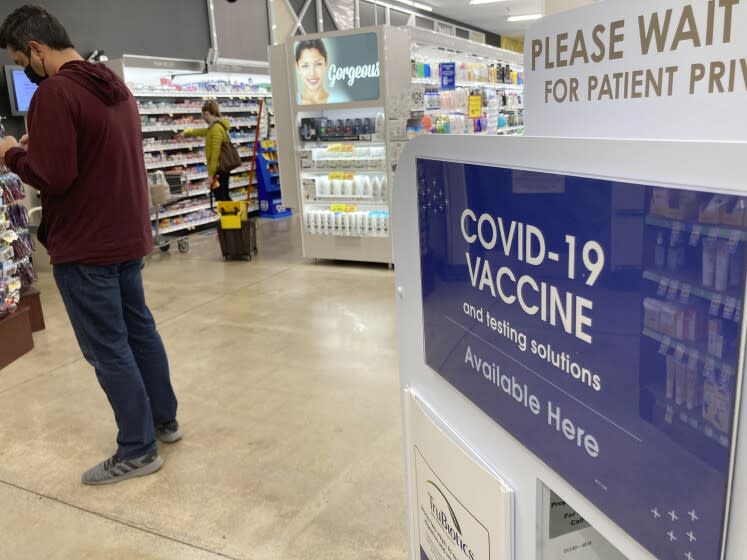 FILE - A patient waits to be called for a COVID-19 vaccination booster shot outside a pharmacy in a grocery store, Wednesday, Nov. 3, 2021, in downtown Denver. Infection rates have soared in Colorado over the past month, and Gov. Jared Polis signed an executive order on Thursday, Nov. 11, 2021, to expand the use of booster shots to quell the recent surge in COVID-19 infections. (AP Photo/David Zalubowski, File)