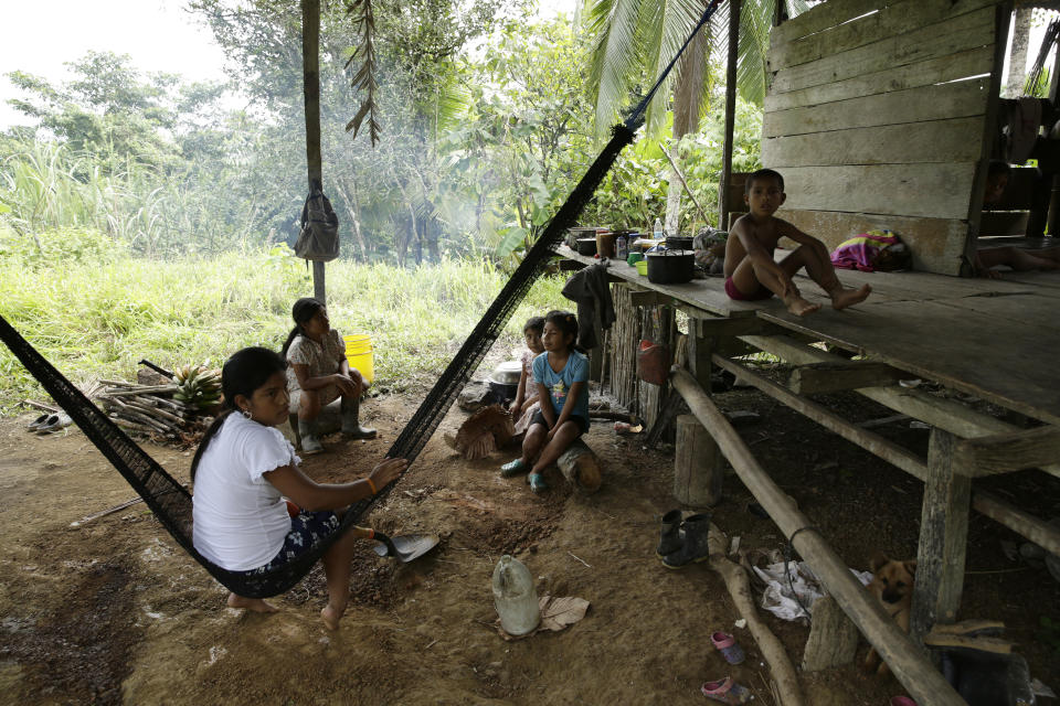 Miembros del grupo indígena Ngabe Bugle están sentados en su hogar en la comunidad de El Terrón, Panamá, el viernes 17 de enero de 2020. (AP foto/Arnulfo Franco)