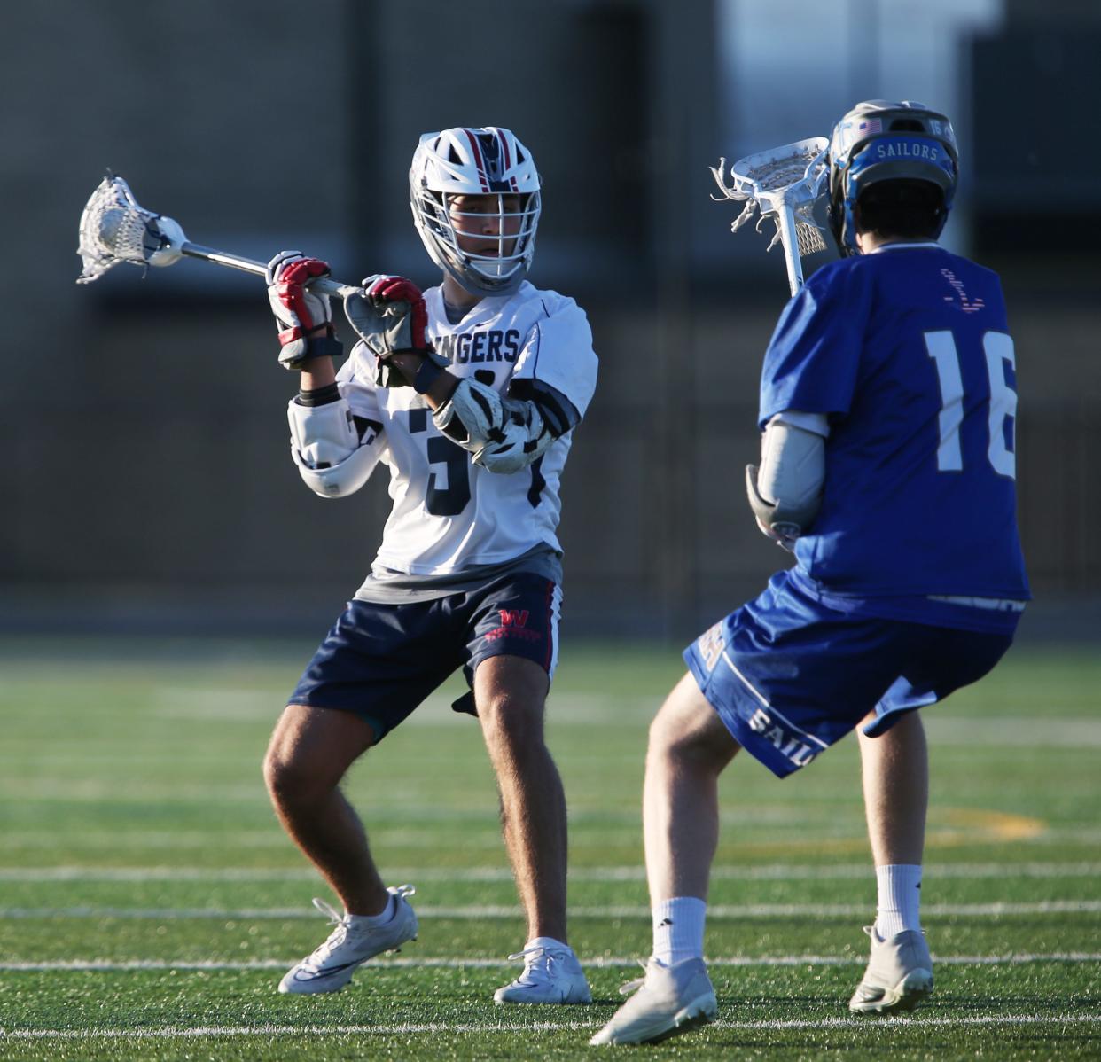 Wappingers' Brayden Kuczma looks to pass the ball away from Hendrick Hudson's Connor Prokopiak during a May 9, 2022 boys lacrosse game.