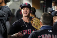 Cleveland Indians starting pitcher Zach Plesac smiles as he greets teammates in the dugout after the seventh inning of the team's baseball game against the Seattle Mariners on Thursday, May 13, 2021, in Seattle. (AP Photo/Elaine Thompson)