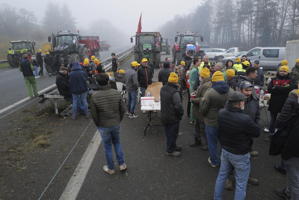 Farmers block a highway, near Agen, southwestern France, Saturday, Jan. 27, 2024. French farmers have vowed to continue protesting and are maintaining traffic barricades on some of the country's major roads. The government announced a series of measures Friday but the farmers say these do not fully address their demands. (AP Photo/Fred Scheiber)
