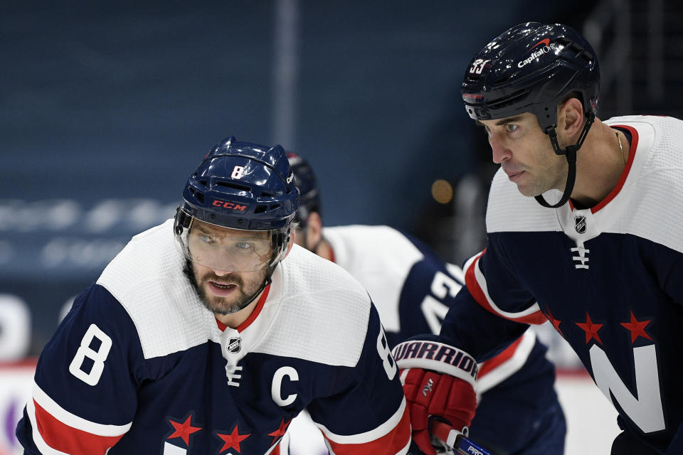 Washington Capitals left wing Alex Ovechkin (8), of Russia, and defenseman Zdeno Chara (33) wait for a faceoff during the first period of an NHL hockey game against the Philadelphia Flyers, Sunday, Feb. 7, 2021, in Washington. (AP Photo/Nick Wass)