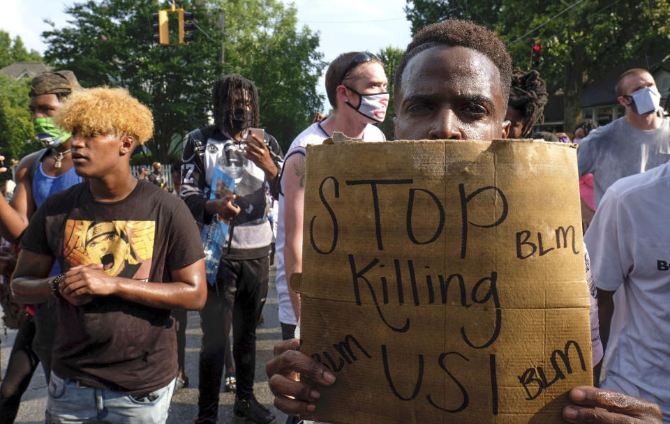 Protesters march from a Wendy's restaurant to a police precinct at Grant Park on Sunday, June 14, 2020, in Atlanta. Rayshard Brooks, a 27-year-old black man, was fatally shot by a white Atlanta police officer outside the Wendy's Friday night. (Ben Gray/Atlanta Journal-Constitution via AP)