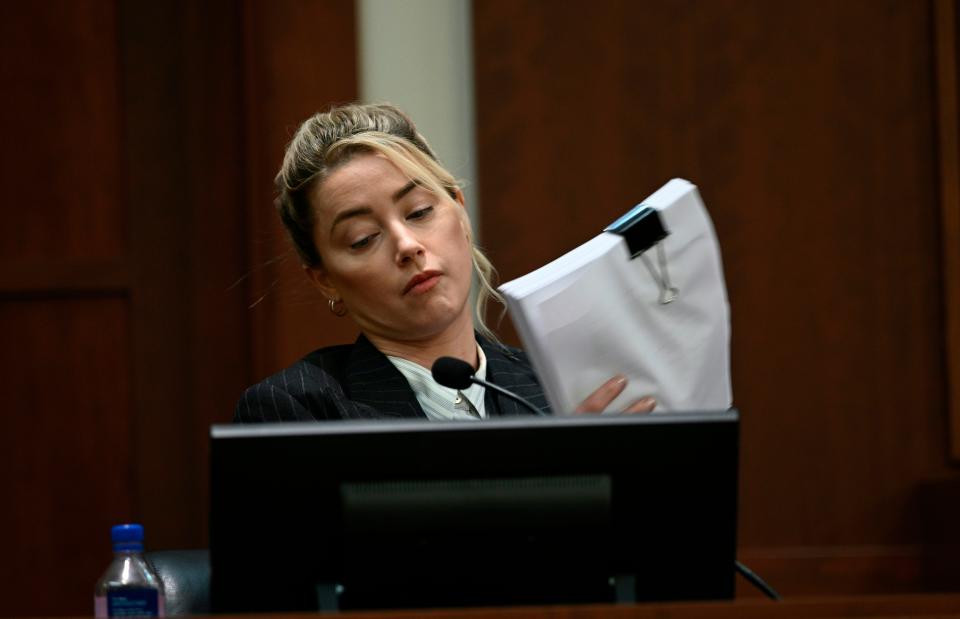 Amber Heard reviews evidence in Johnny Depp libel lawsuit Tuesday, May 17, 2022.