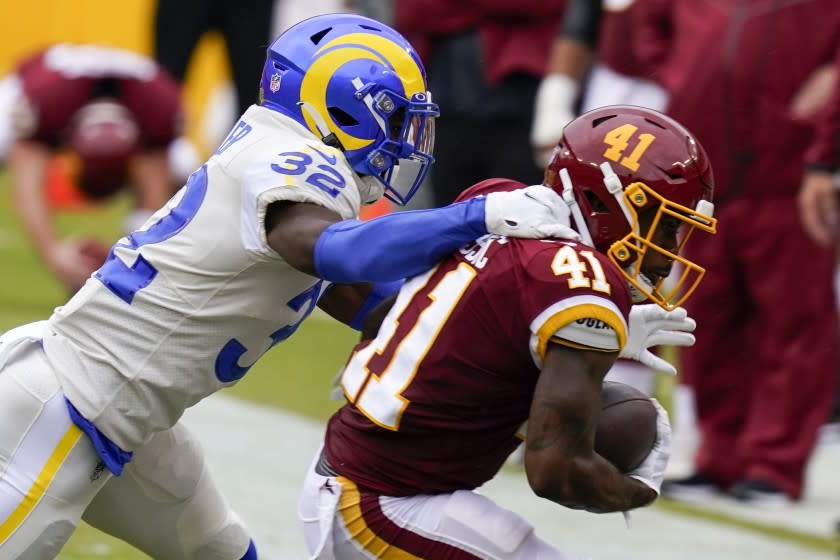 Washington Football Team's J.D. McKissic is stopped by Los Angeles Rams' Jordan Fuller during the first half of an NFL football game Sunday, Oct. 11, 2020, in Landover, Md. (AP Photo/Steve Helber)