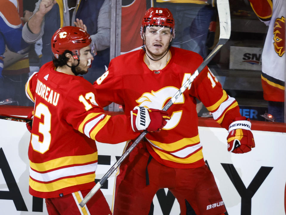 Calgary Flames forward Matthew Tkachuk, right, celebrates his goal against the Edmonton Oilers with forward Johnny Gaudreau during the second period of Game 1 of an NHL hockey second-round playoff series Wednesday, May 18, 2022, in Calgary, Alberta. (Jeff McIntosh/The Canadian Press via AP)