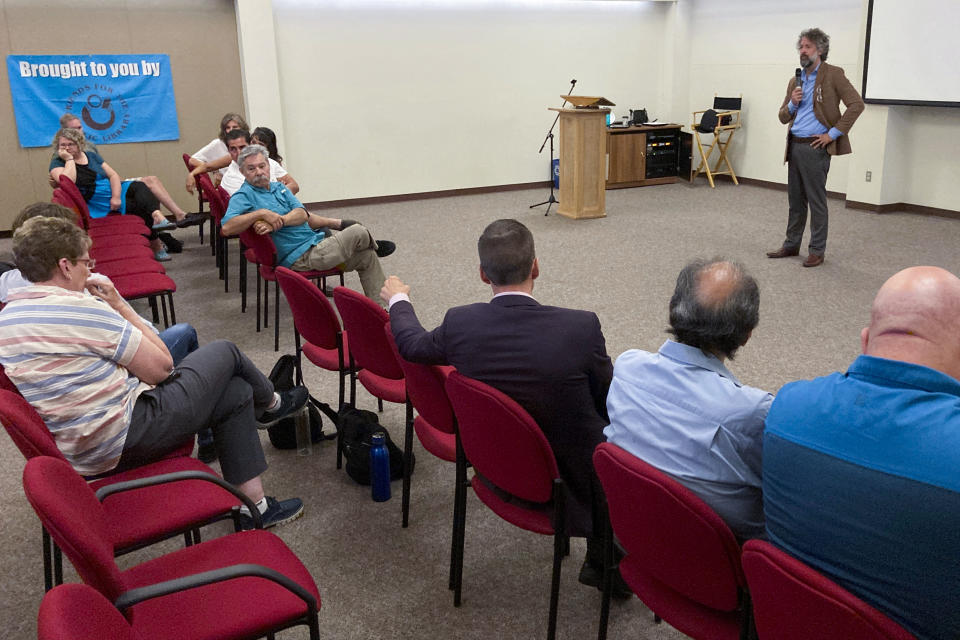 David Clements, a New Mexico-based former prosecutor and former college professor, speaks to an audience at a public library auditorium in Albuquerque, N.M., Sept. 3, 2022. At conventions, church gatherings and local forums, Clements advocates for eliminating electronic election equipment and exonerating many of the defendants charged in the violent Jan. 6, 2021, attack on the U.S. Capitol. (AP Photo/Morgan Lee)