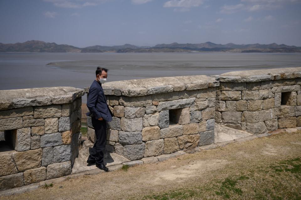 A visitor stands at a viewpoint overlooking the North Korean shoreline (C) and the Demilitarized Zone (DMZ) separating North and South Korea, on the South Korean island of Ganghwa on April 23, 2020. - The United States will keep seeking North Korea's denuclearization no matter who is in charge in Pyongyang, Secretary of State Mike Pompeo said, amid speculation about leader Kim Jong Un's health. (Photo by Ed JONES / AFP) (Photo by ED JONES/AFP via Getty Images)