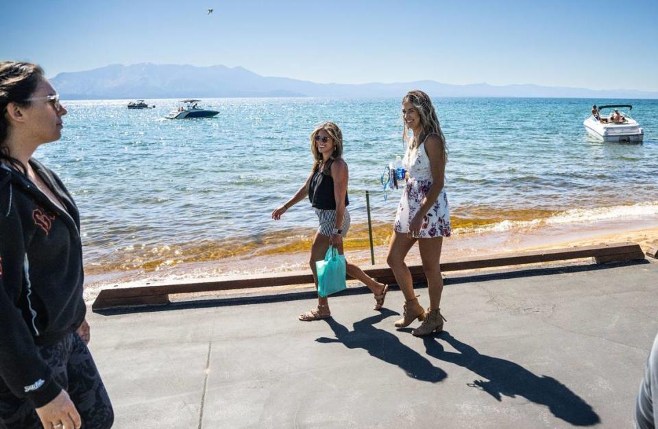 Golf fans walk along the beach on Thursday, July 13, 2023 as celebrities get in their final practice round for the American Century Championship celebrity golf tournament at Edgewood Tahoe Golf Course in Stateline, Nev.