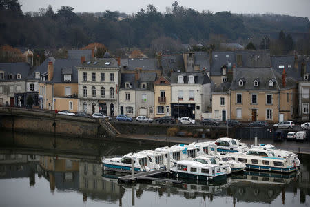 Boats and houses are reflected in the Sarthe River in Sable-sur-Sarthe, western France, January 31, 2017. REUTERS/Stephane Mahe