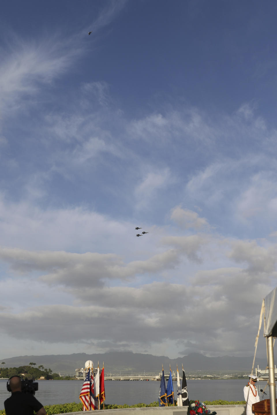 Military jets fly a missing man formation during a ceremony marking the anniversary of the Japanese attack on Pearl Harbor, Monday, Dec. 7, 2020, in Pearl Harbor, Hawaii. Officials gathered in Pearl Harbor to remember those killed in the 1941 Japanese attack, but public health measures adopted because of the coronavirus pandemic meant no survivors were present. The military broadcast video of the ceremony live online for survivors and members of the public to watch from afar. A moment of silence was held at 7:55 a.m., the same time the attack began 79 years ago. (AP Photo/Caleb Jones, Pool)