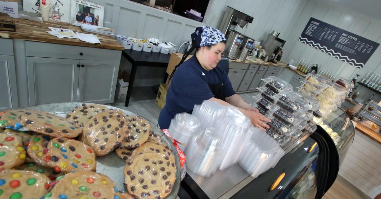 Aliya Wilson puts out Oreo cake slices inside the new location of Floyd & Blackies Bakery on Eighth Avenue in Cramerton Friday morning, June 2, 2023.
