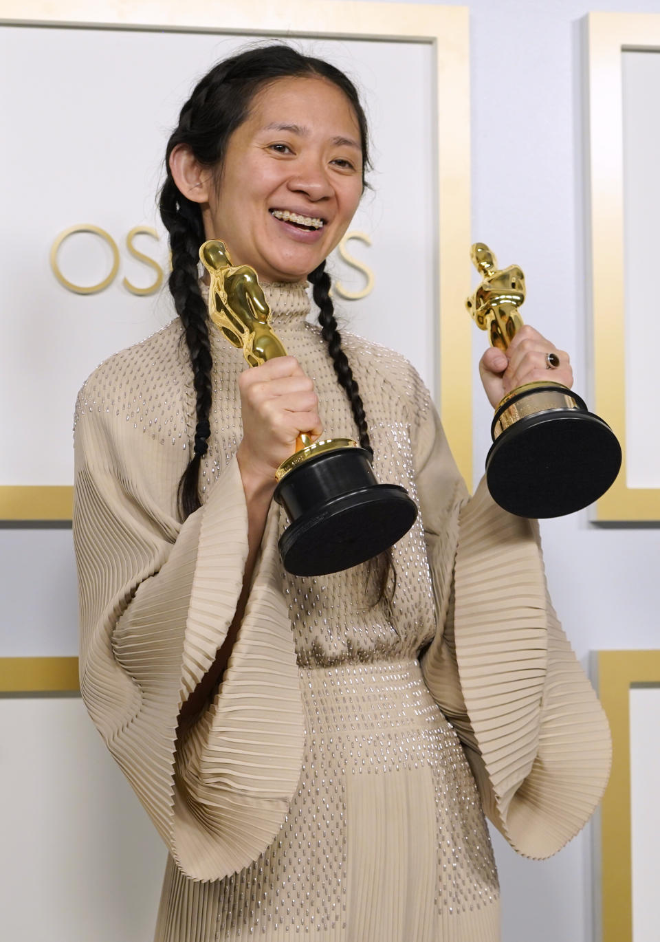 FILE - Chloe Zhao, winner of the awards for best picture and director for "Nomadland," poses in the press room at the Oscars in Los Angeles on April 25, 2021. (AP Photo/Chris Pizzello, File)