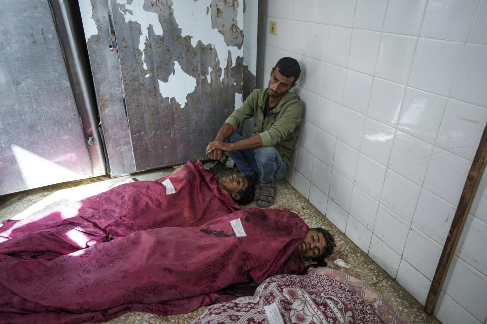 Palestinians mourn the bodies of their relatives killed in an Israeli bombardment of the Gaza Strip, at the Al Aqsa hospital in Deir al Balah, central Gaza Strip, on Monday, May 27, 2024. (AP Photo/Abdel Kareem Hana)