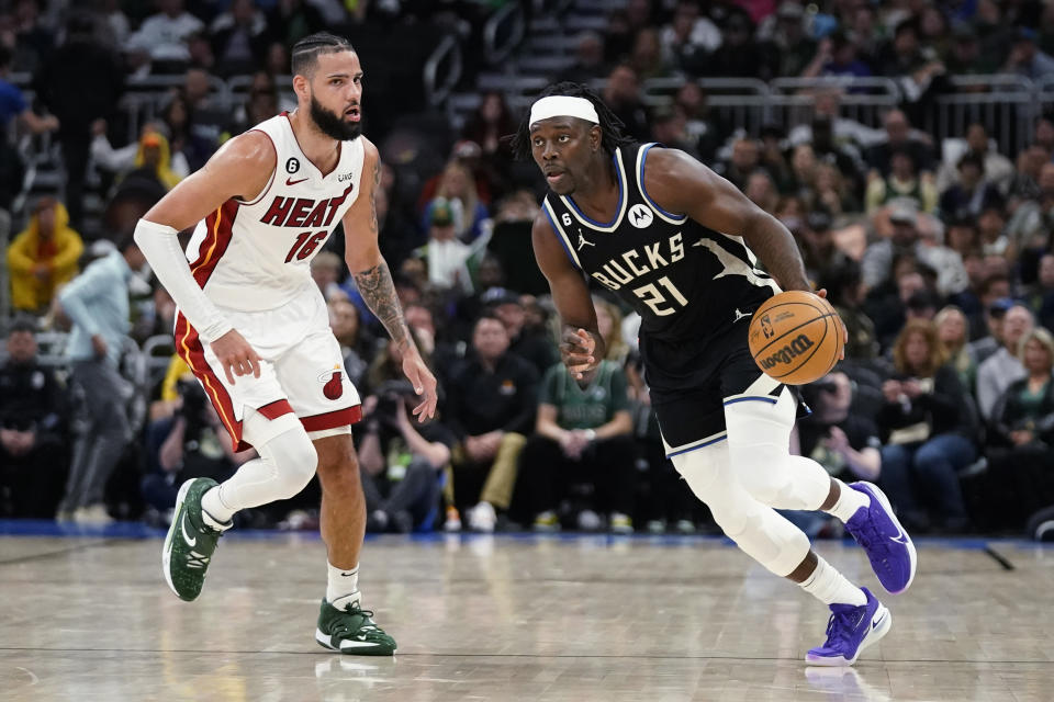 Milwaukee Bucks' Jrue Holiday (21) drives against Miami Heat's Caleb Martin during the second half of Game 2 of an NBA basketball first-round playoff series Wednesday, April 19, 2023, in Milwaukee. (AP Photo/Aaron Gash)