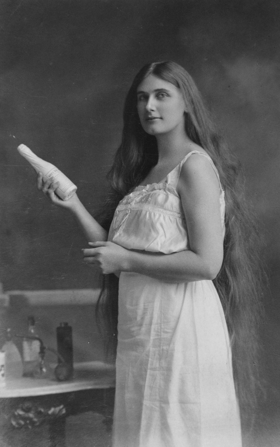 <p>A long-haired lingerie model poses with a bottle in her hand for a shampoo ad.</p>