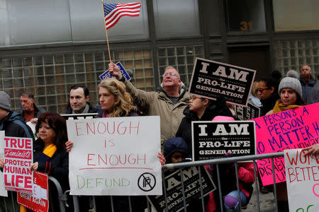 People gather during an anti-Planned Parenthood vigil outside the Planned Parenthood - Margaret Sanger Health Center in Manhattan, New York, U.S., February 11, 2017. REUTERS/Andrew Kelly