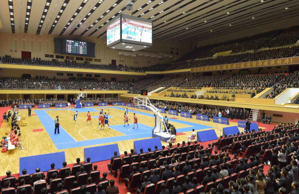 North Korean leader Kim Jong Un watches a basketball game between former U.S. NBA basketball players and North Korean players of the Hwaebul team of the DPRK with Dennis Rodman at Pyongyang Indoor Stadium