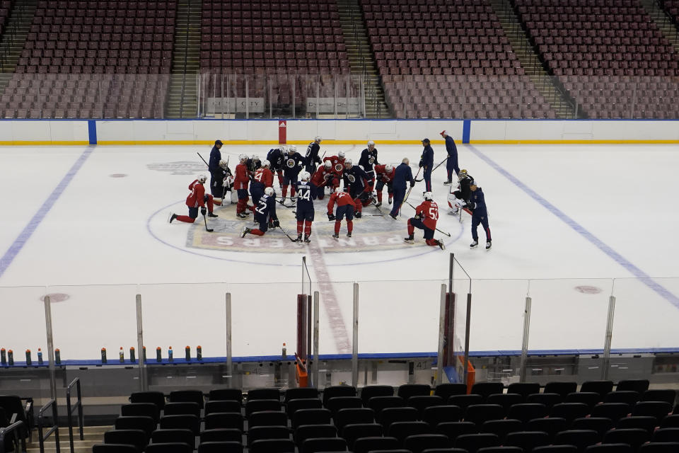 Florida Panthers players huddle on center ice during an NHL hockey training camp, Friday, Sept. 24, 2021, in Sunrise, Fla. (AP Photo/Wilfredo Lee)