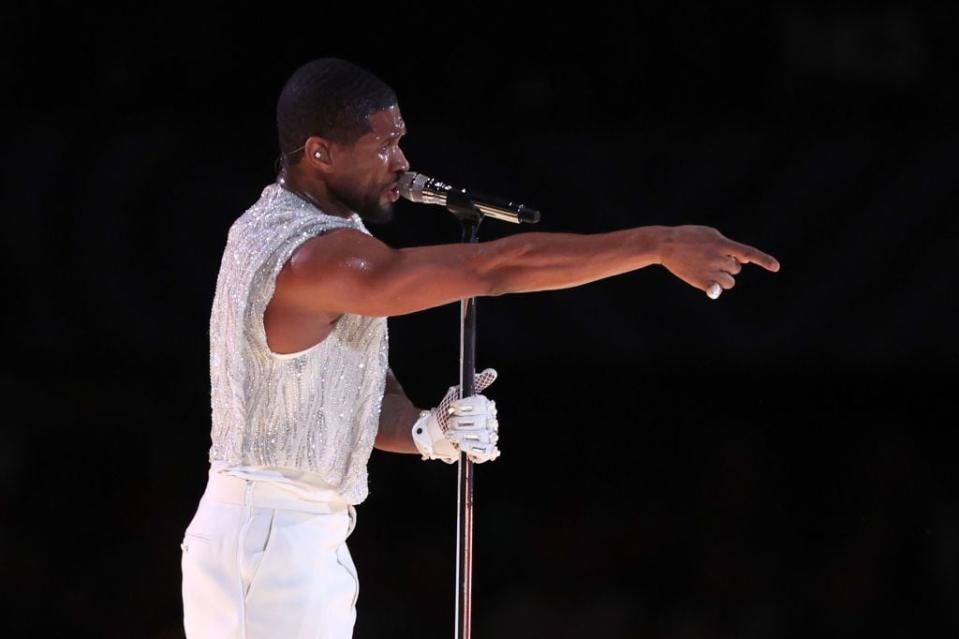 Usher makes his point during Sunday's halftime show at Super Bowl LVIII.