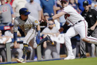 Milwaukee Brewers third baseman Luis Urias (2) is tagged out by Atlanta Braves third baseman Austin Riley (27) after he was caught in a rundown during the fifth inning of Game 3 of a baseball National League Division Series, Monday, Oct. 11, 2021, in Atlanta. (AP Photo/John Bazemore)