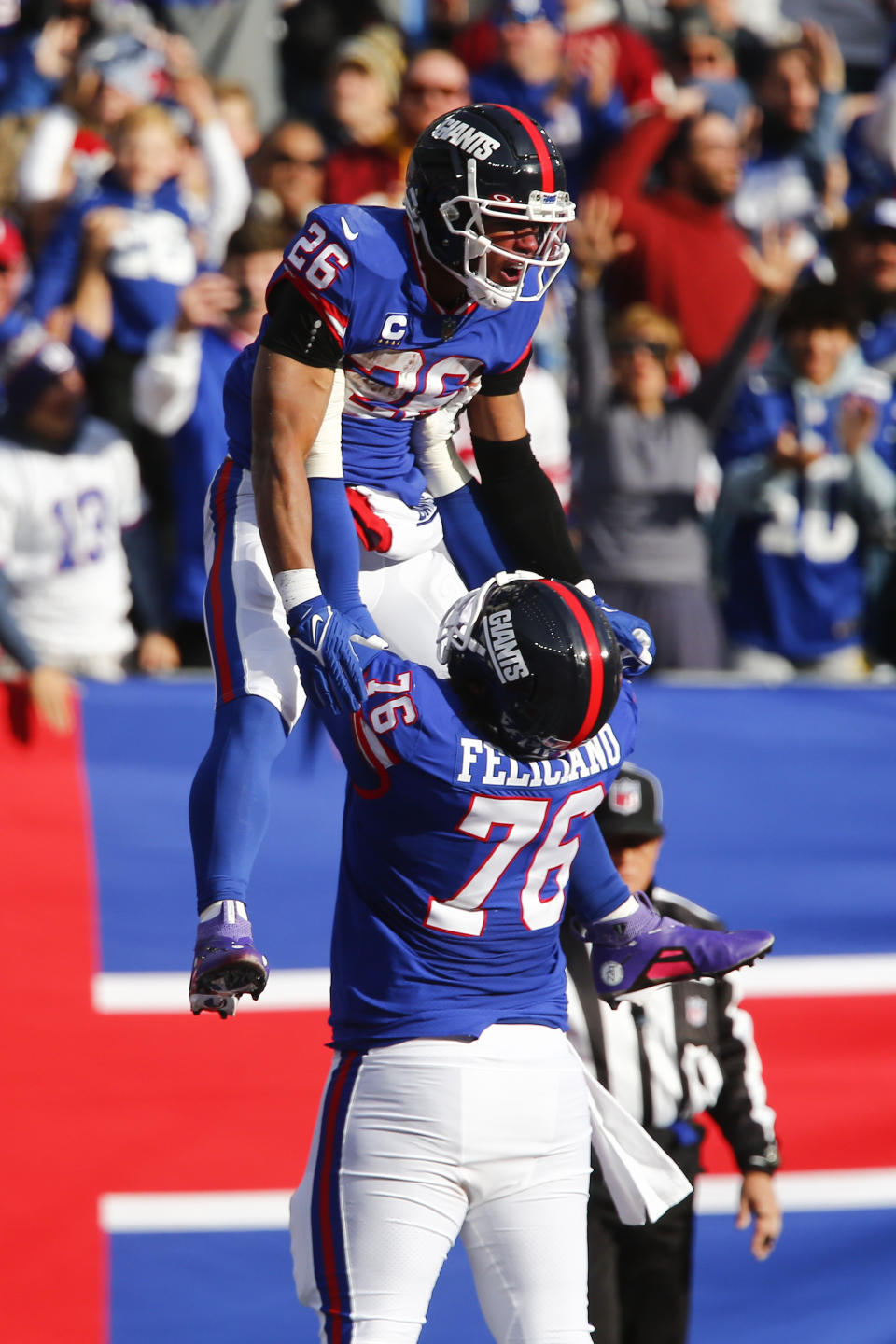 New York Giants' Saquon Barkley, left, celebrates his touchdown with Jon Feliciano during the first half of an NFL football game against the Washington Commanders, Sunday, Dec. 4, 2022, in East Rutherford, N.J. (AP Photo/John Munson)