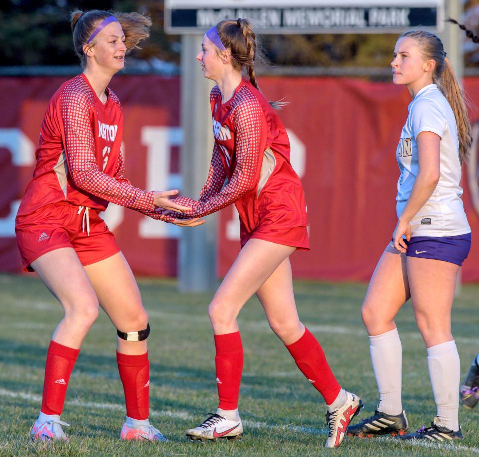 Morton's Addie Dea, left, congratulates teammate Edie Hart on a goal in the first half of their soccer match Tuesday, March 28, 2023 at McClallen Park in Morton. The Potters defeated the Little Giants 9-0.